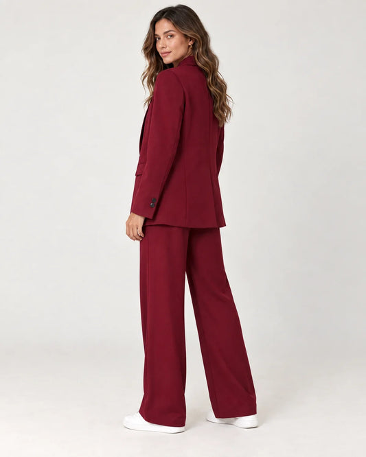Solveig women's longline blazer suit set with wide-leg trousers in Dark Red, side view on a model