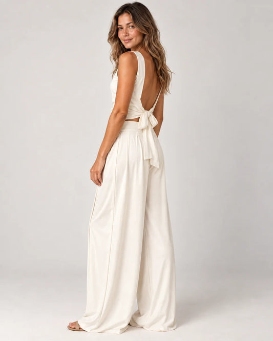 Odalie women's open-back crop top and wide-leg pant set in ivory white, side view on a model