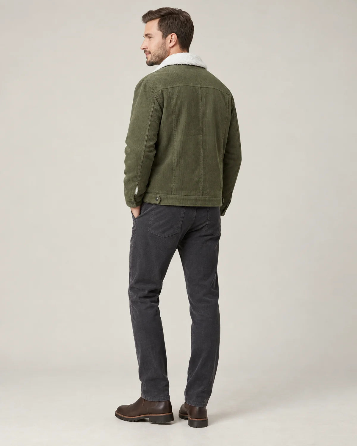 Everett men's corduroy sherpa lined trucker jacket in army green, three-quarter back view showing the yoke and hem tabs