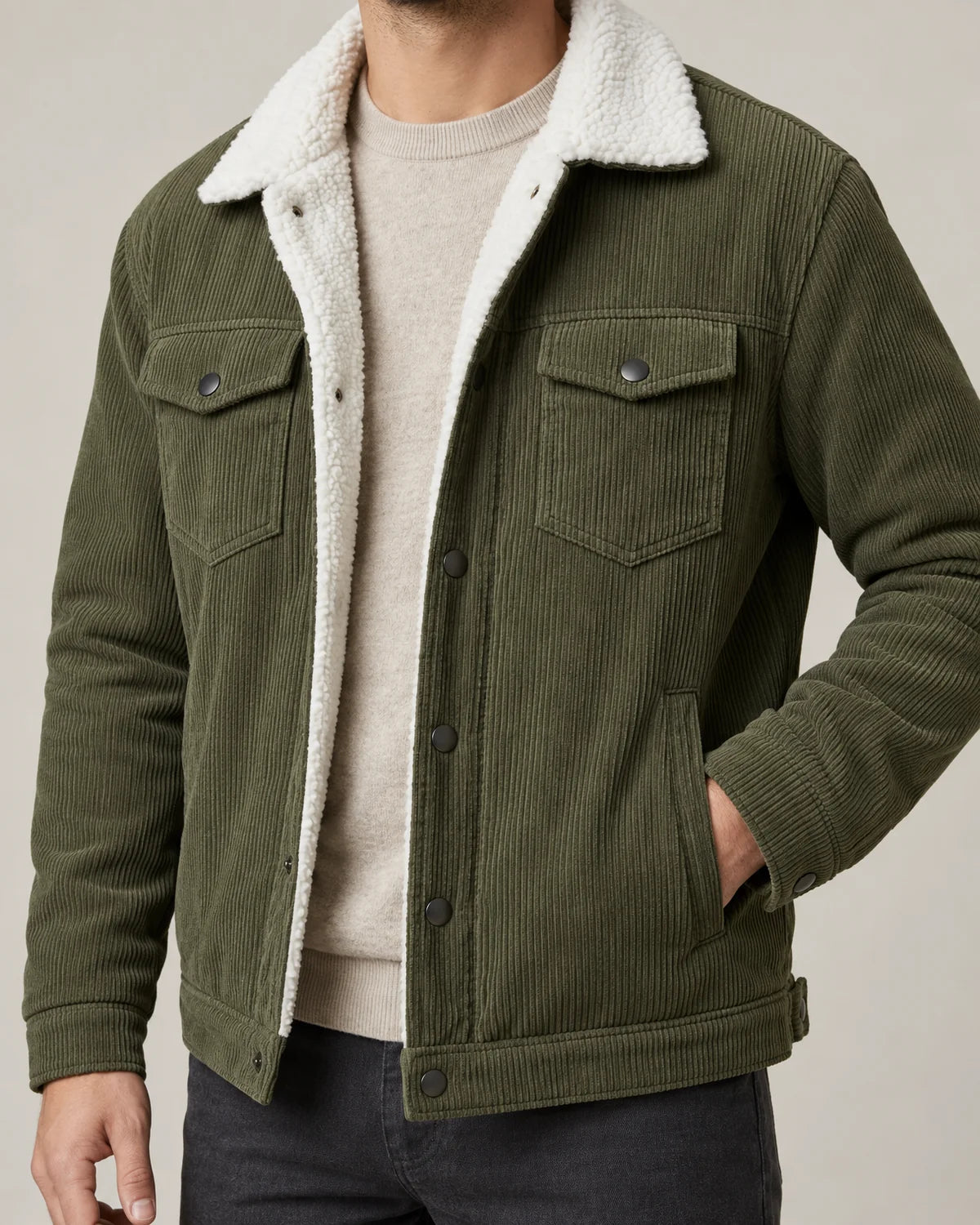 Everett men's corduroy sherpa lined trucker jacket in army green, close-up of the sherpa collar, snap chest pocket and corduroy texture