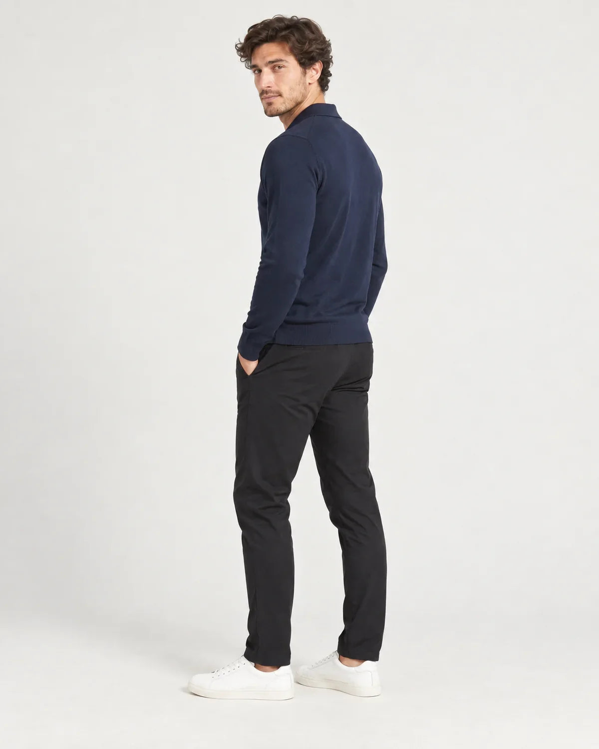 Foster men's slim-fit knitted polo jumper in Navy, side view on a model