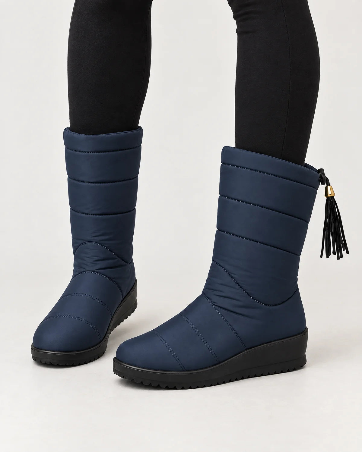 Sigrid women's quilted mid-calf winter boots with tassel tie in Navy, worn with black leggings