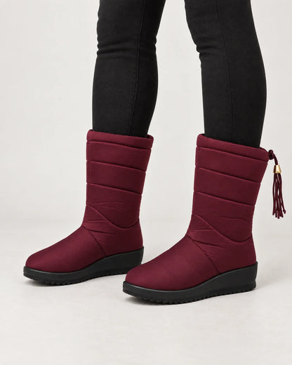 Sigrid women's quilted mid-calf winter boots with tassel tie in Burgundy, worn with black leggings