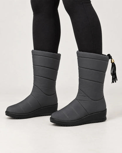 Sigrid women's quilted mid-calf winter boots with tassel tie in Gray, worn with black leggings