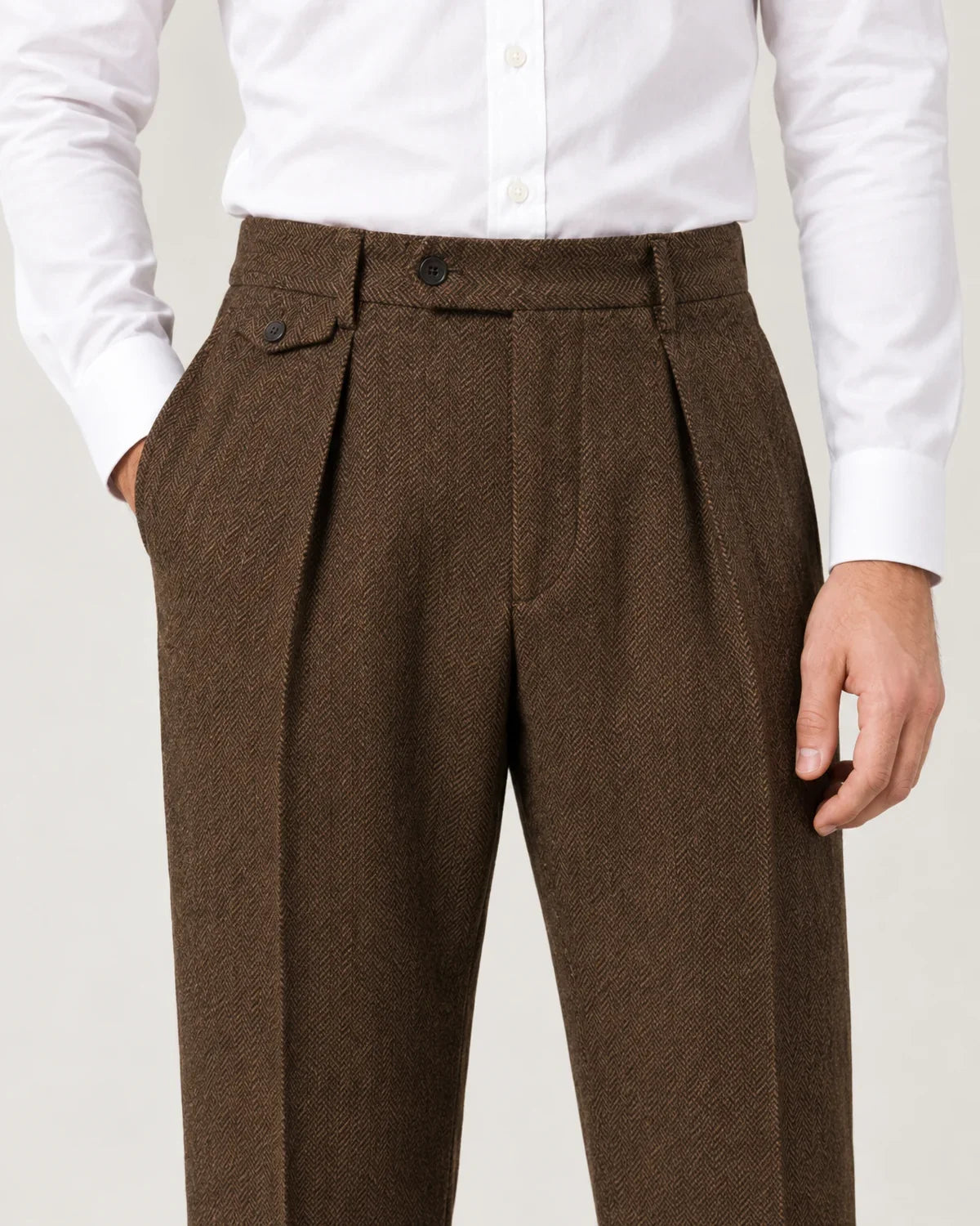 Sinclair men's herringbone pleated straight-leg trousers in Brown, close-up detail of the fabric and closure