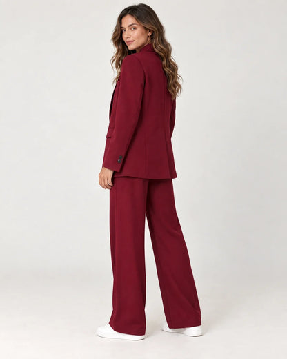 Solveig women's longline blazer suit set with wide-leg trousers in Dark Red, side view on a model