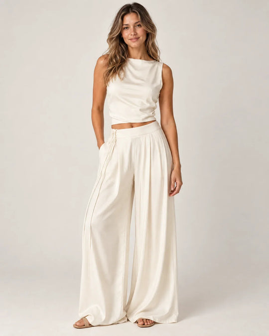 Odalie women's open-back crop top and wide-leg pant set in ivory white, front view on a model