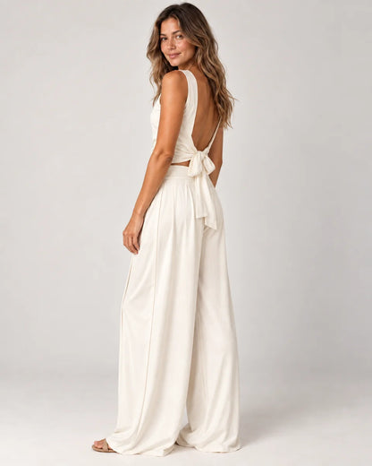 Odalie women's open-back crop top and wide-leg pant set in ivory white, side view on a model