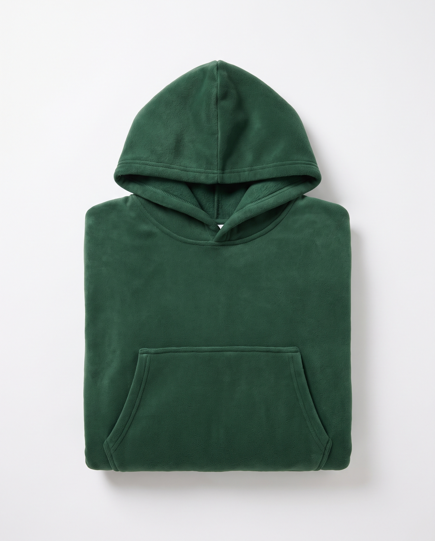 Hazel oversized hooded blanket in forest green, folded flat on white with the hood and front pocket visible